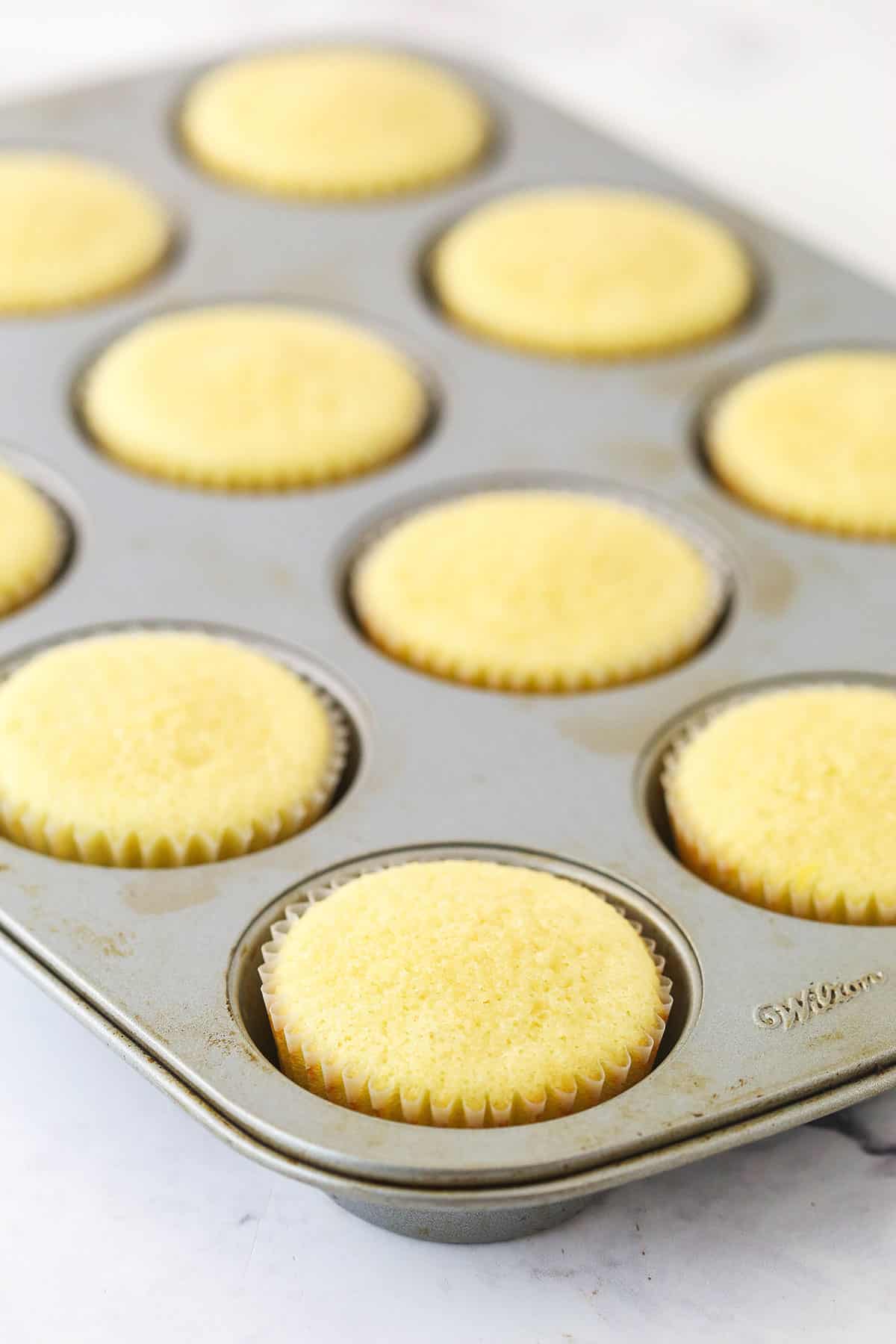 Overhead view of baked cupcakes in a cupcake pan