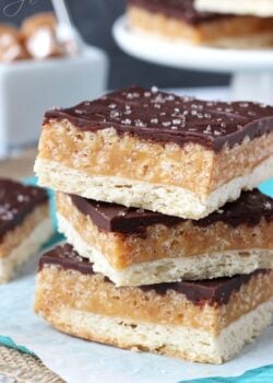 A Close-Up Shot of Three Stacked Chocolate Caramel Cookie Bars Topped with Sea Salt