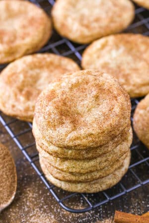 A stack of snickerdoodles on a wire rack.