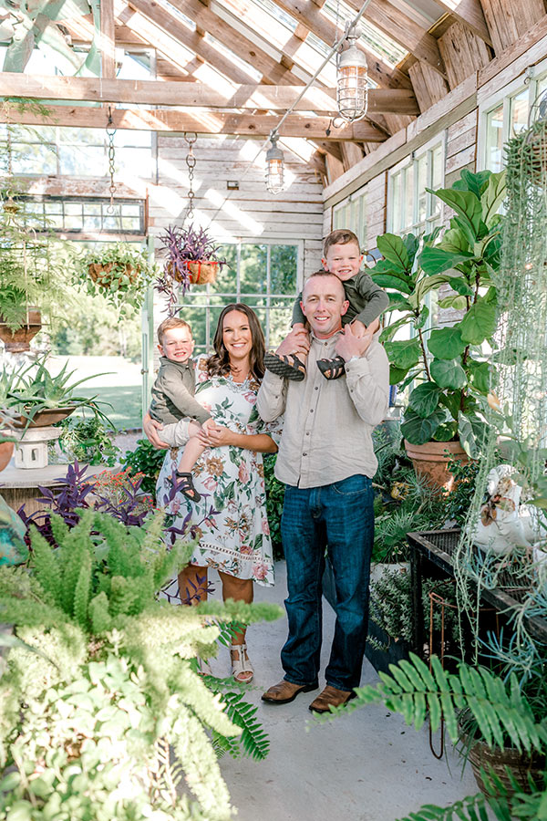 Family photo standing in greenhouse