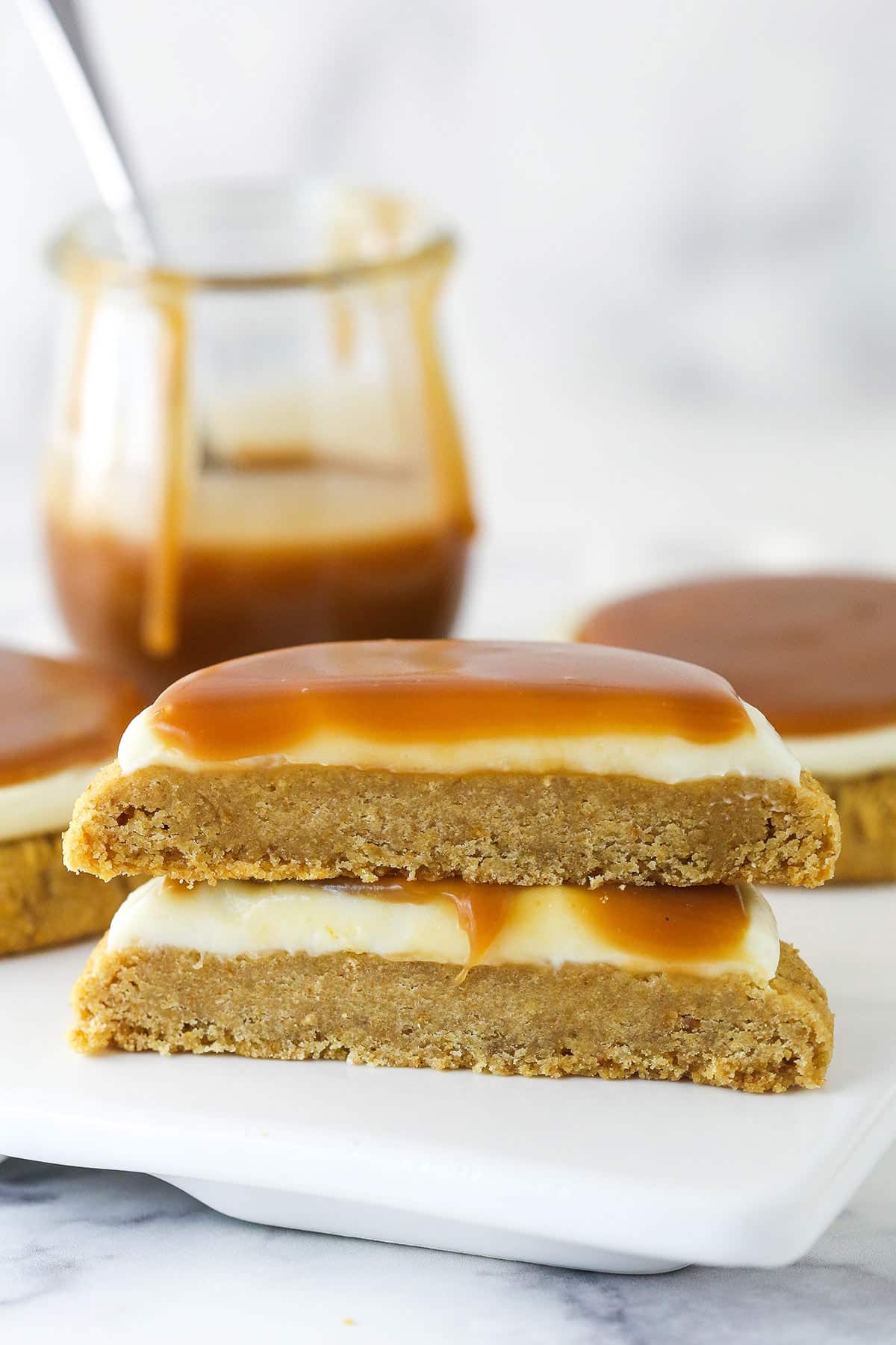 2 halves of a salted caramel cheesecake cookie stacked on top of each other.