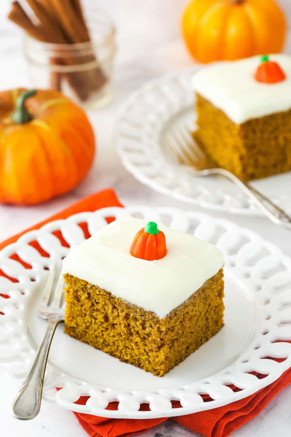Slice of pumpkin cake with cream cheese frosting.