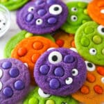 Close up of a pile of brightly colored Halloween Monster Cookies with eyeballs.