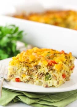 A piece of hashbrown breakfast casserole on a plate ready to be eaten