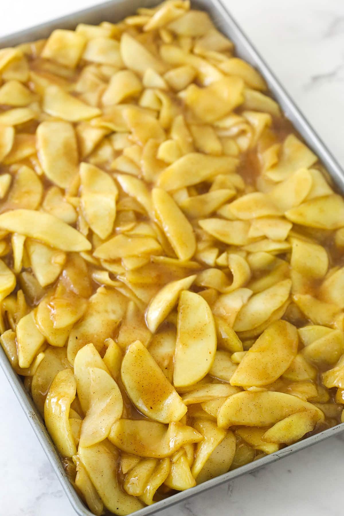 Cooling apple pie filling on a sheet pan.