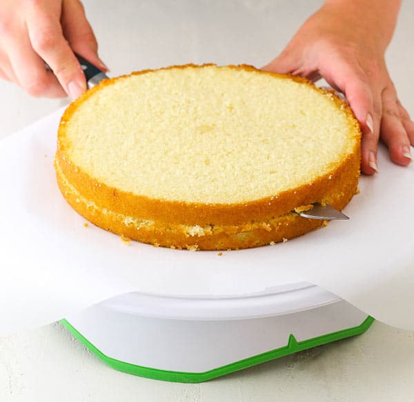 serrated knife torting cake into layers