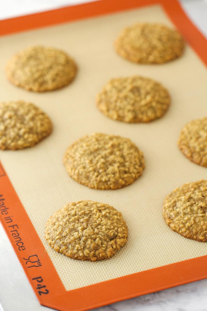 Silicon baking mat with 8 cooked Moist Banana Oatmeal Cookies.