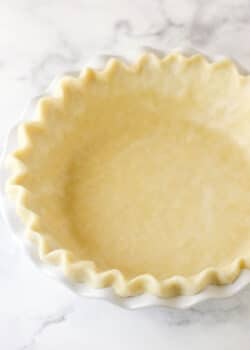 unbaked pie crust in white pie plate