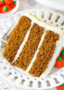 A slice of pumpkin layer cake on a plate.