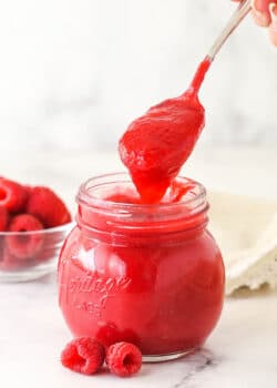 Raspberry filling for cake in a glass jar.