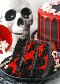 red and black. marble cake slice with skull in the background