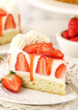 slice of strawberry shortcake cheesecake on white plate