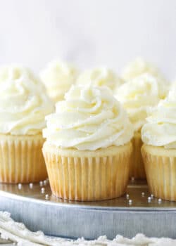 White cupcakes on a serving tray.