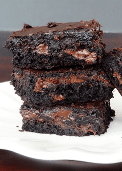 Brownies stacked on white plate